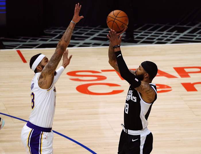 Apr 4, 2021; Los Angeles, California, USA; Los Angeles Clippers forward Marcus Morris Sr. (8) shoots against Los Angeles Lakers forward Markieff Morris (88) during the first half at Staples Center. Mandatory Credit: Gary A. Vasquez-USA TODAY Sports